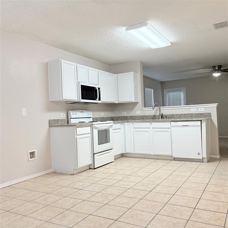 1826 Trailview Drive Terrell, TX 75160 - Photo 6 of 27 a white kitchen with a sink and cabinets