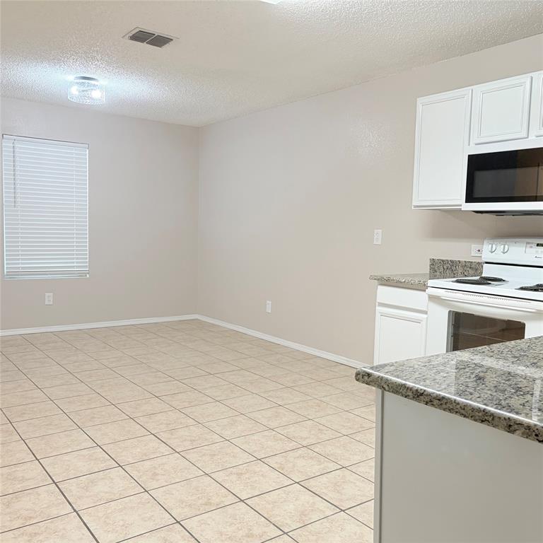 1826 Trailview Drive Terrell, TX 75160 - Photo 8 of 27 a view of a kitchen with microwave and cabinets