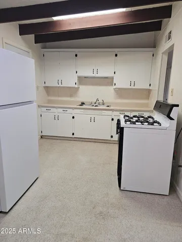 a kitchen with cabinets and white appliances