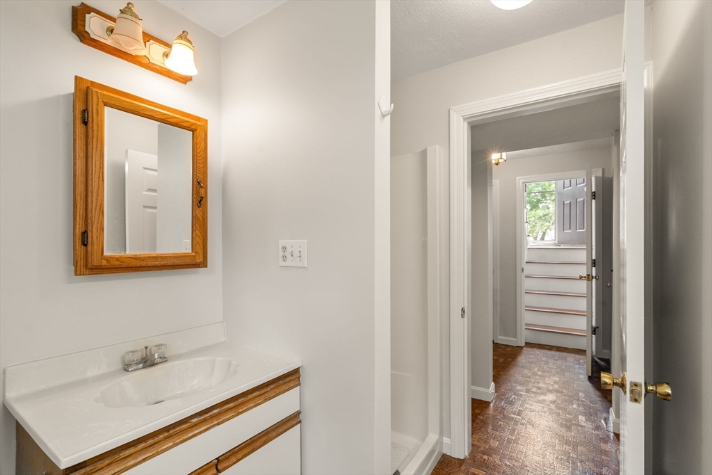 16 Shelley Road Arlington, MA 02476 - Photo 23 of 30 a bathroom with a sink a mirror and a toilet