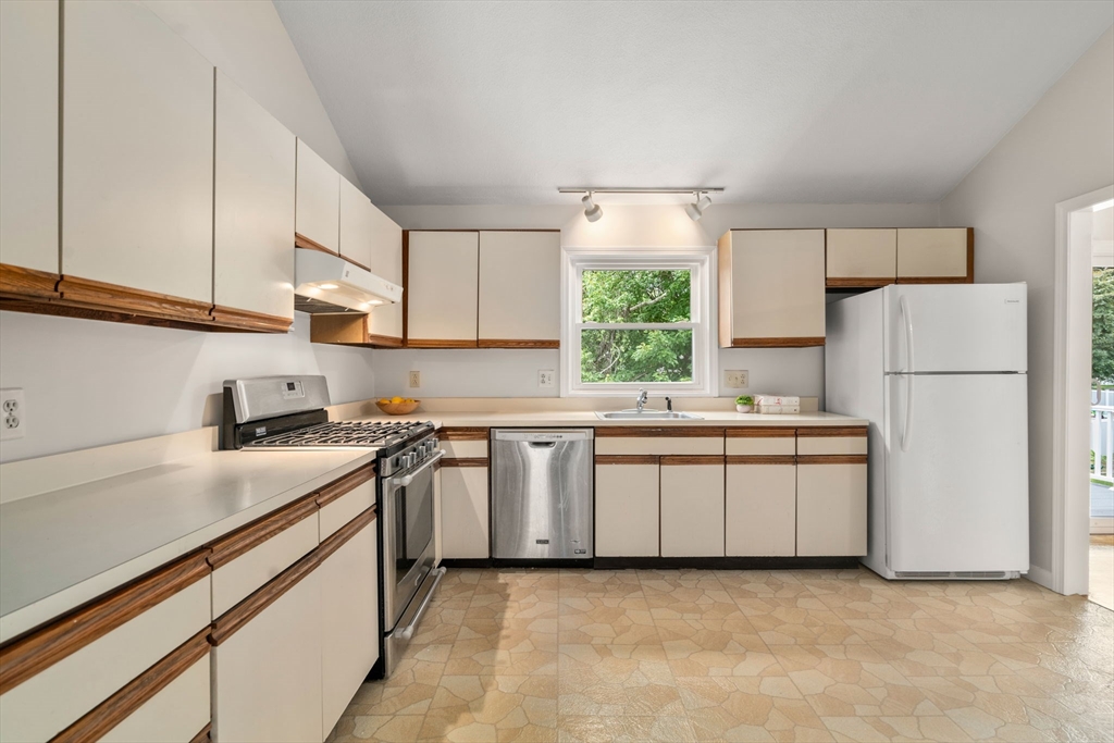 16 Shelley Road Arlington, MA 02476 - Photo 9 of 30 a kitchen with a white cabinets stove and refrigerator