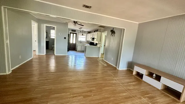 a view of a hallway with wooden floor