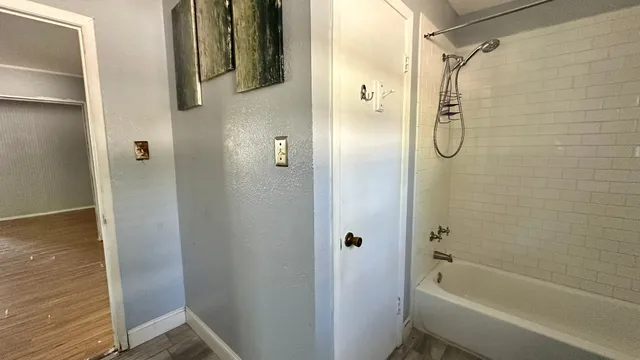 a bathroom with a shower and a bath tub