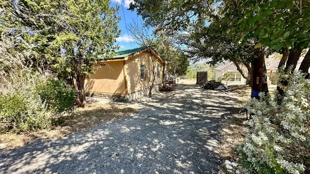 a backyard of a house with table and chairs