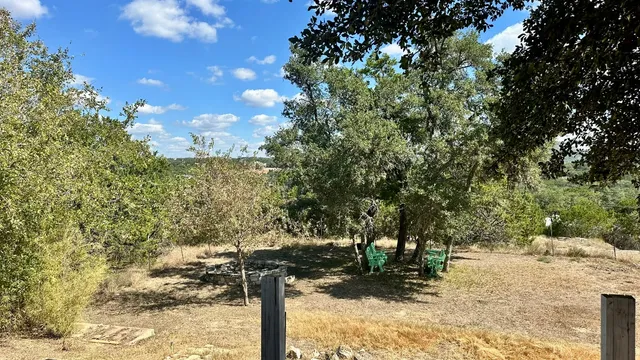 a view of a yard with wooden fence