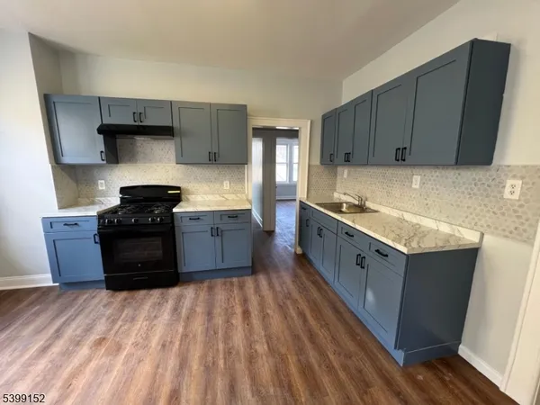 a kitchen with stainless steel appliances granite countertop a sink a stove and a refrigerator