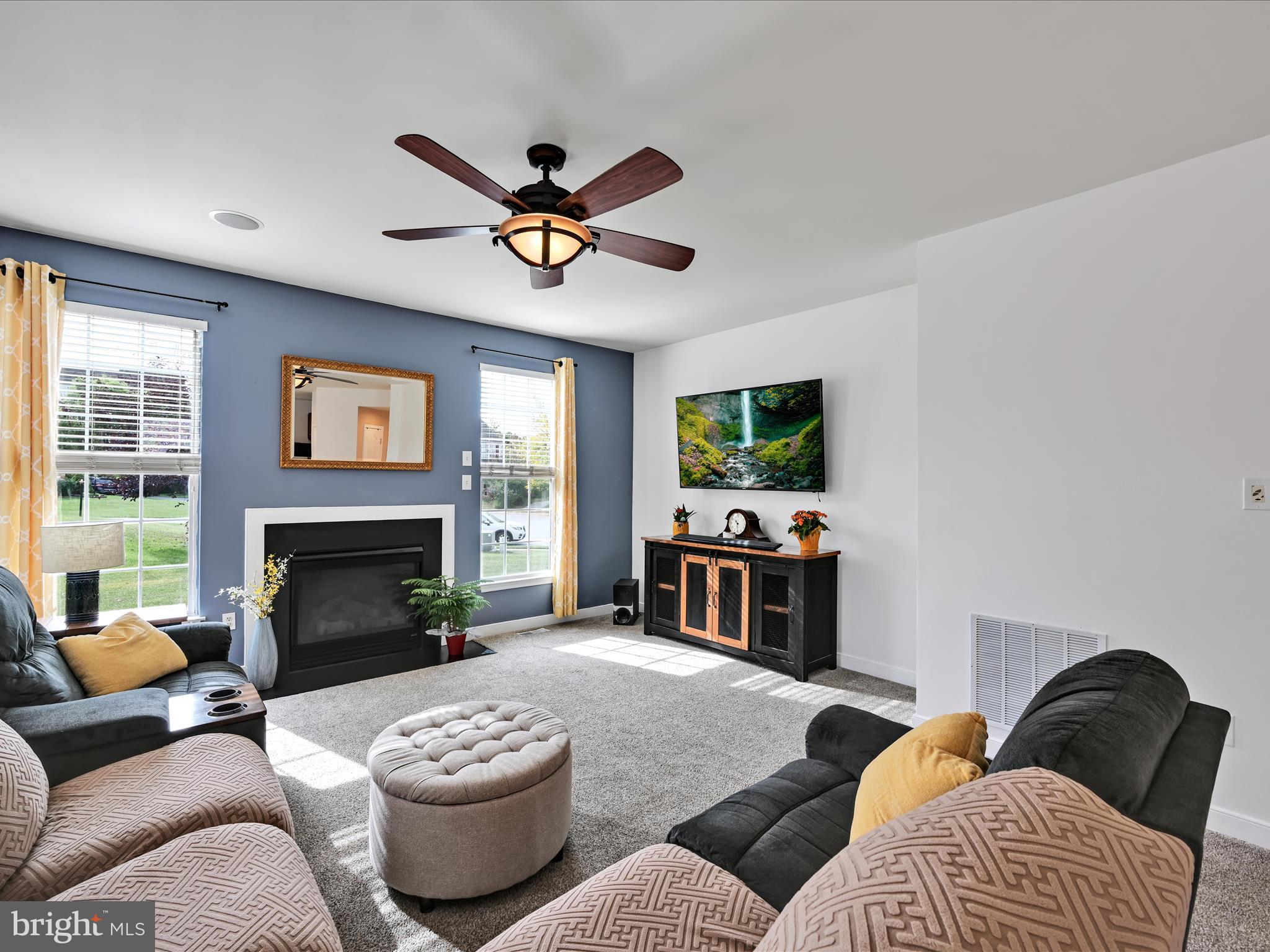 7641 Pinewild Road Seven Valleys, PA 17360 - Photo 13 of 42 a living room with furniture a fireplace and a flat screen tv