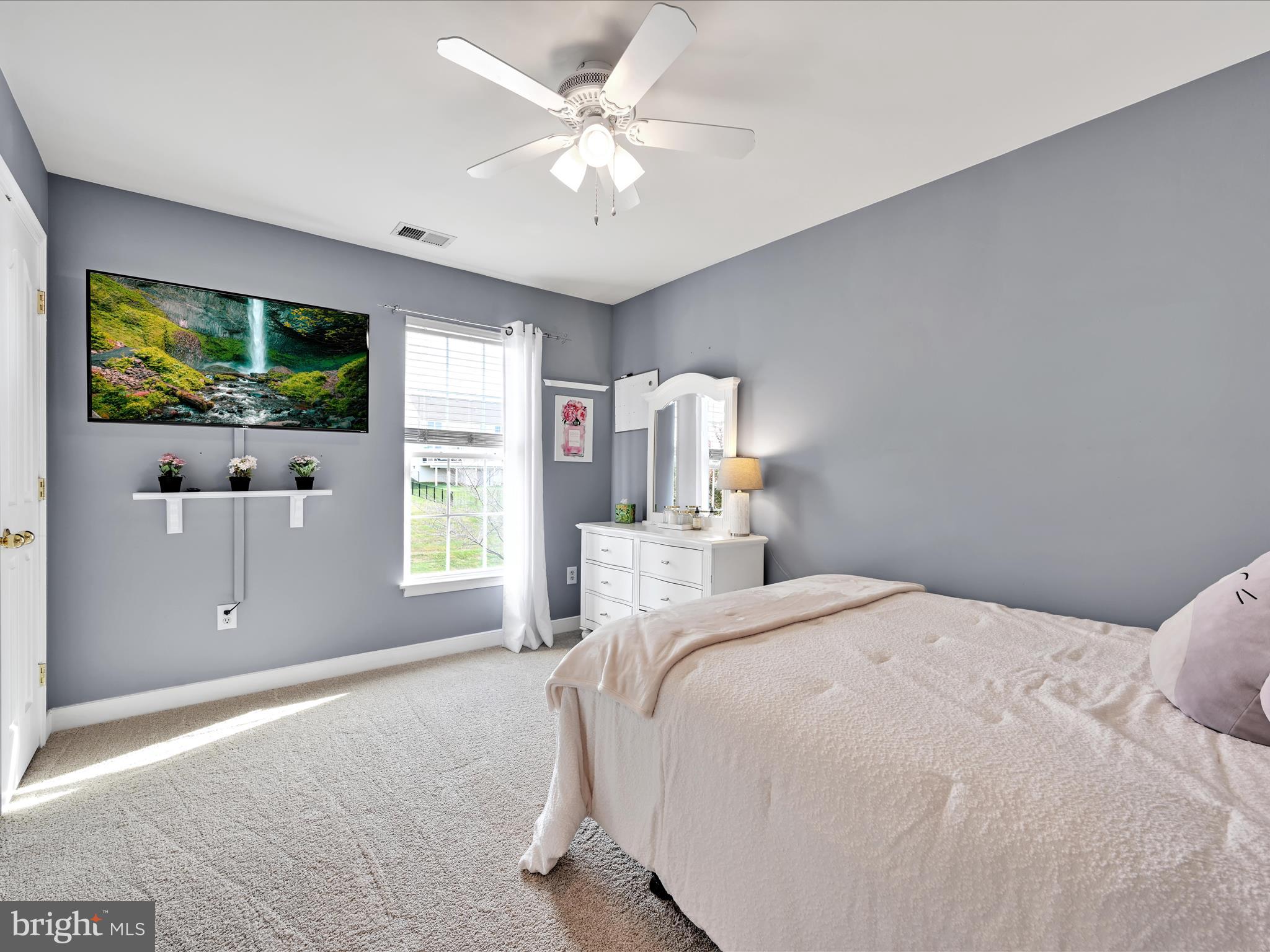 7641 Pinewild Road Seven Valleys, PA 17360 - Photo 24 of 42 a bedroom with a large bed and a flat screen tv