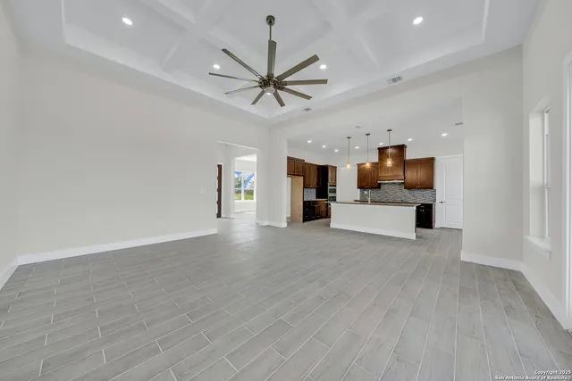 a view of kitchen with cabinets and wooden floor