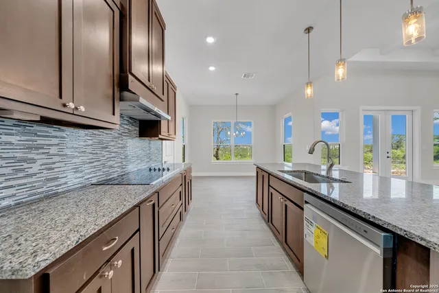 a kitchen with stainless steel appliances granite countertop counter space a sink and cabinets