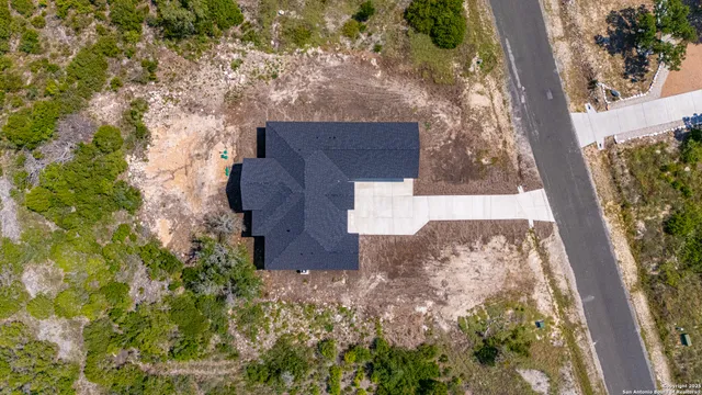 an aerial view of a house with a yard