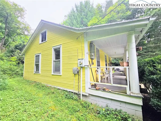 a view of a house with a chairs and table in a patio