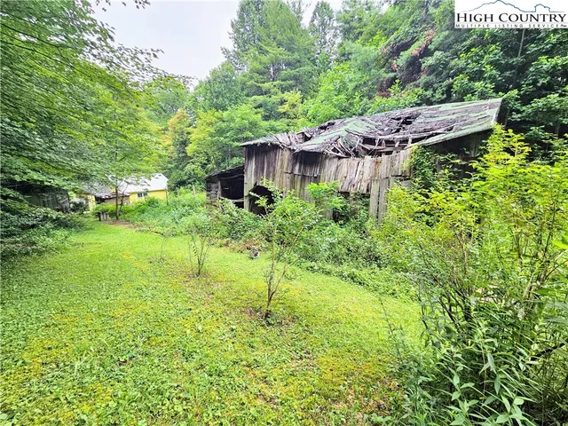 a backyard of a house with a yard and outdoor seating