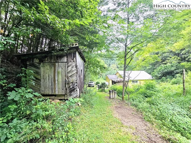 a view of a house with a backyard and garden