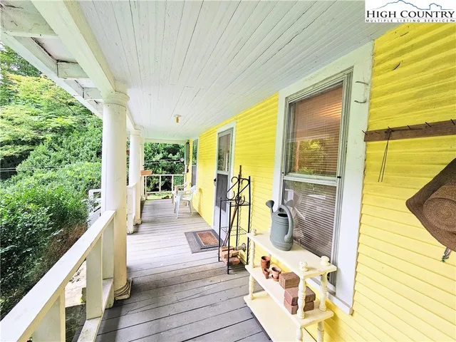 a view of a patio with wooden floor and iron stairs