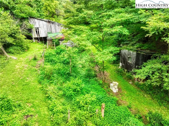 a aerial view of a house with garden and trees