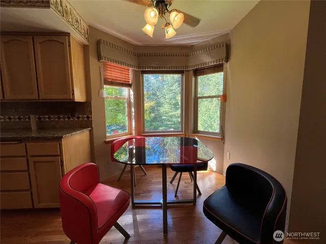 a view of a room that has a bed chair and a window