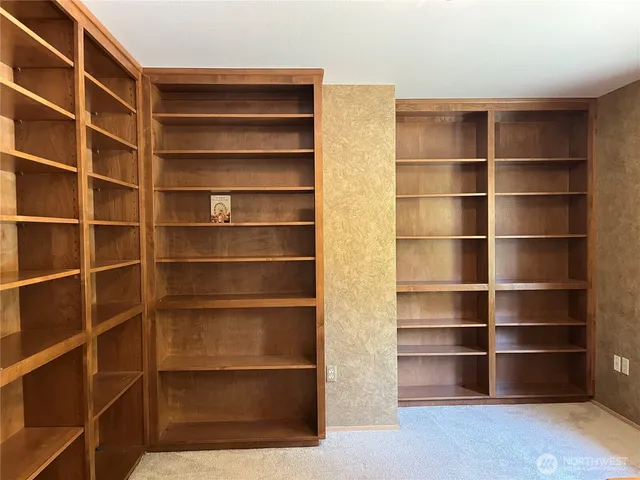 a view of walk in closet with empty racks