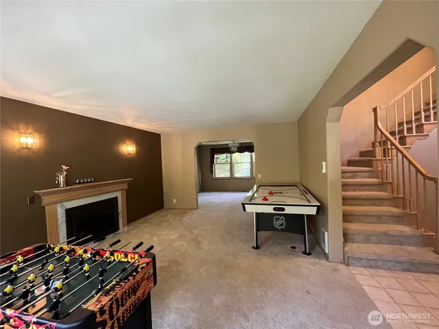 an empty room with windows and chandelier fan