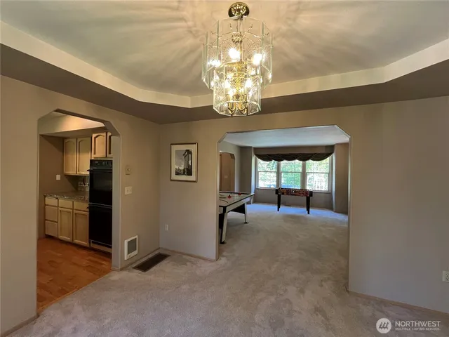 a kitchen with stainless steel appliances granite countertop a sink dishwasher stove and refrigerator