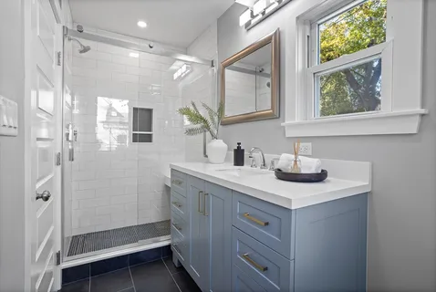 a bathroom with a shower sink and mirror