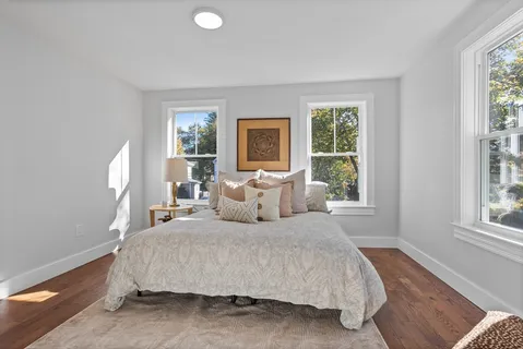 a bedroom with a bed and a large window