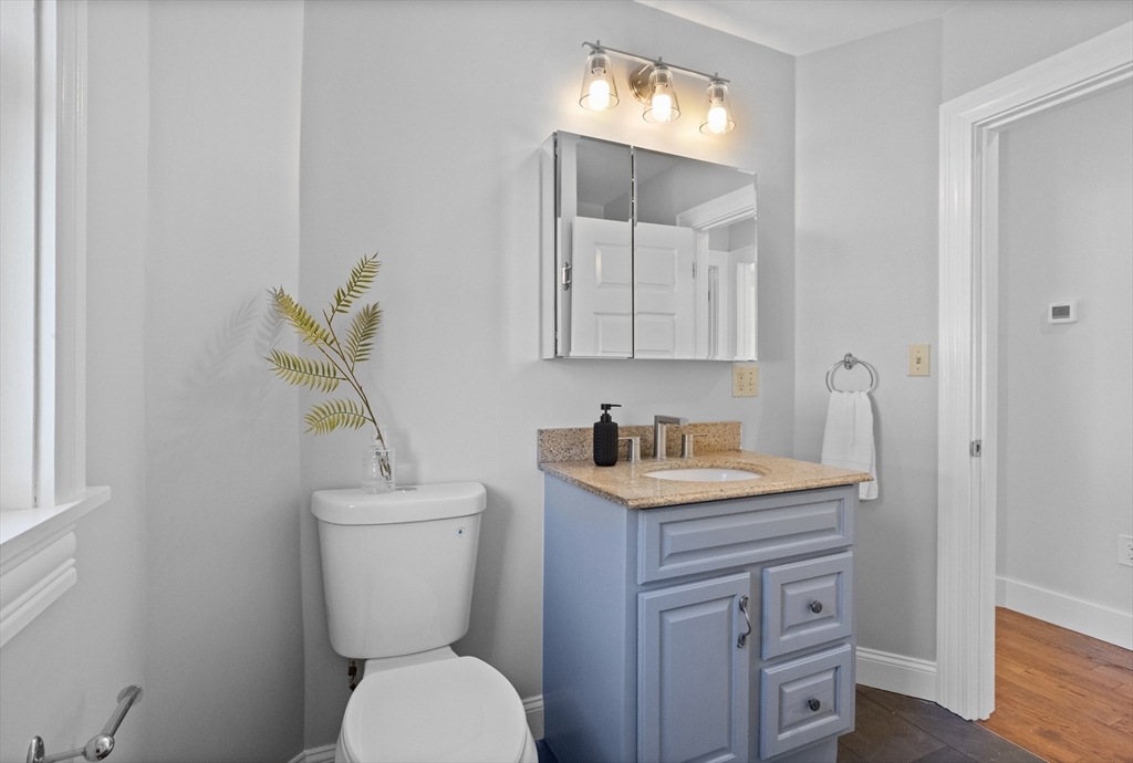 20 Tremont Street Maynard, MA 01754 - Photo 21 of 29 a bathroom with a toilet sink and mirror