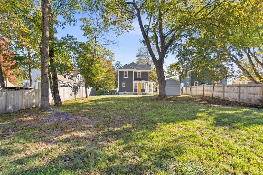 20 Tremont Street Maynard, MA 01754 - Photo 25 of 29 a view of a yard with a house and a large tree