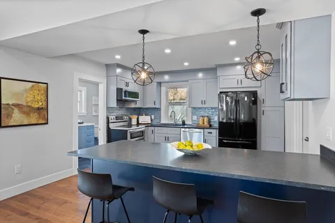 a view of a dining room with furniture and wooden floor