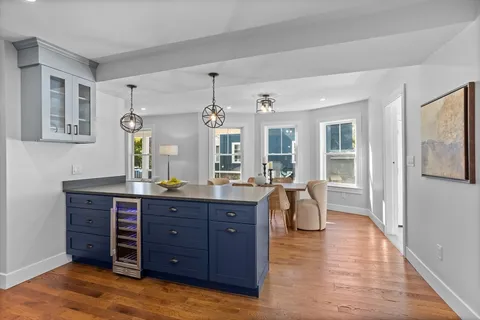 a spacious bathroom with a granite countertop sink mirror and window