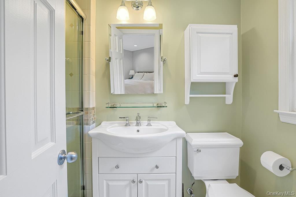 305 Stratton Road New Rochelle, NY 10804 - Photo 17 of 32 a bathroom with a sink mirror and toilet