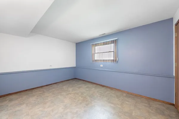 a view of an empty room with workspace and closet