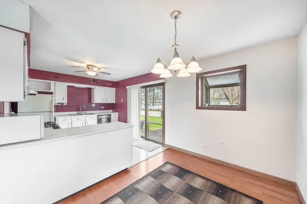 a kitchen with stainless steel appliances kitchen island granite countertop a stove and a refrigerator