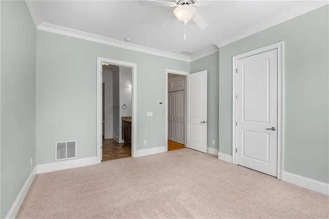 a view of a room with a ceiling fan