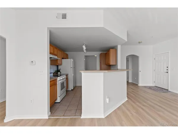 a view interior of kitchen and hall with wooden floor