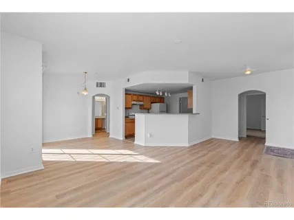 a view of empty room with wooden floor