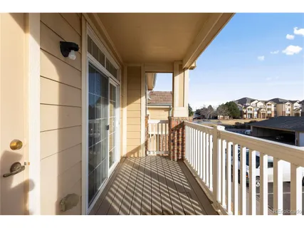 a view of a balcony with wooden floor