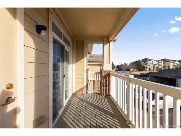 a view of a balcony with wooden floor