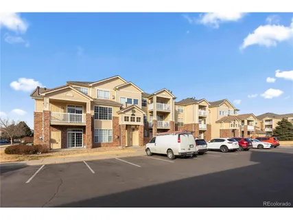 a view of building with car parked