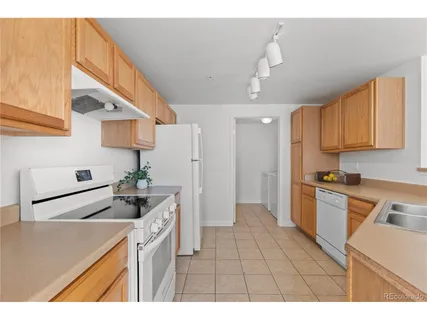 a kitchen with granite countertop a sink stainless steel appliances and cabinets