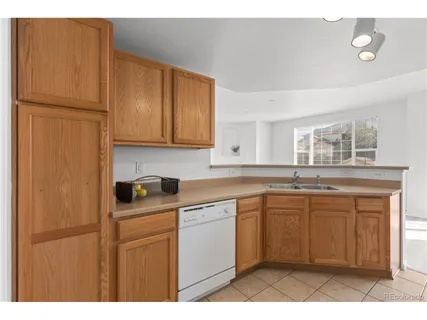 a kitchen with a sink a stove and cabinets