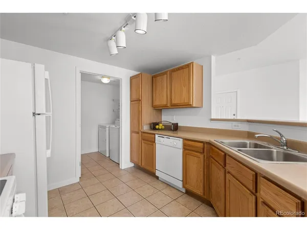 a kitchen with a sink cabinets and appliances