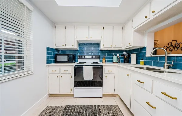 a kitchen with cabinets and white appliances