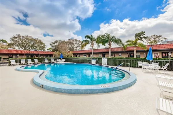a view of a swimming pool with lawn chairs