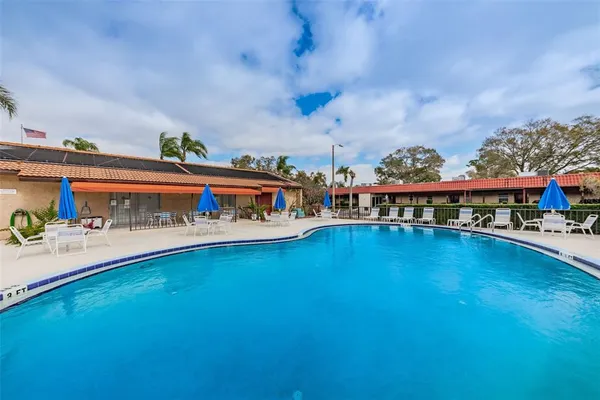 a swimming pool with outdoor seating and yard