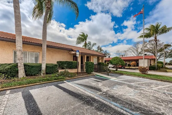 a front view of a house with a yard and potted plants