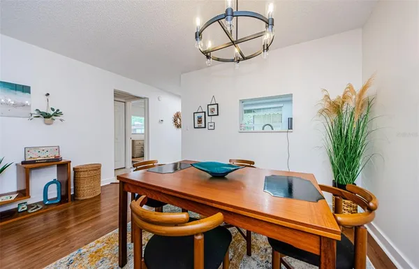 a view of a dining room with furniture and wooden floor