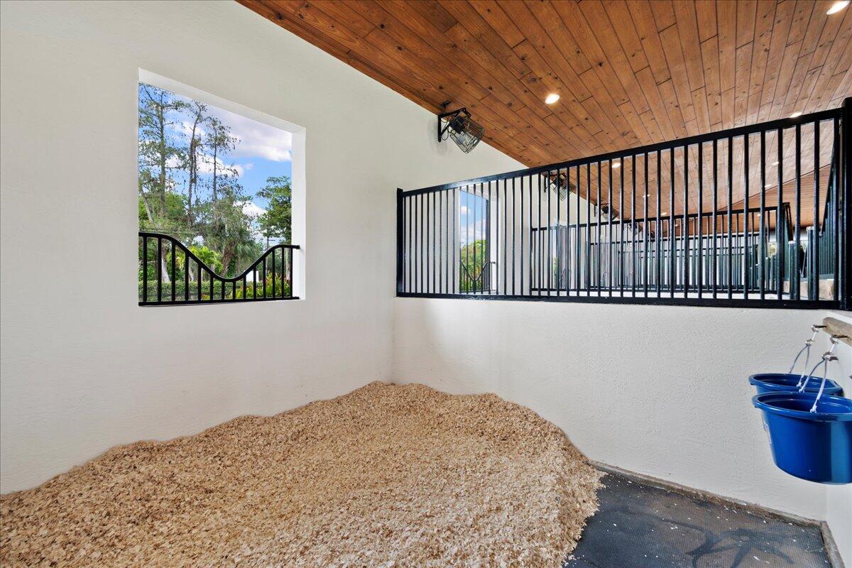 16575 Van Gogh Boulevard, Unit HORSE STALLS) Loxahatchee, FL 33470 - Photo 14 of 50 a bedroom with bed and a window