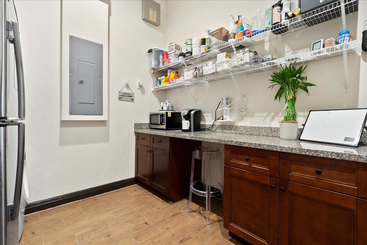 16575 Van Gogh Boulevard, Unit HORSE STALLS) Loxahatchee, FL 33470 - Photo 22 of 50 a kitchen with a potted plant on the counter and cabinets