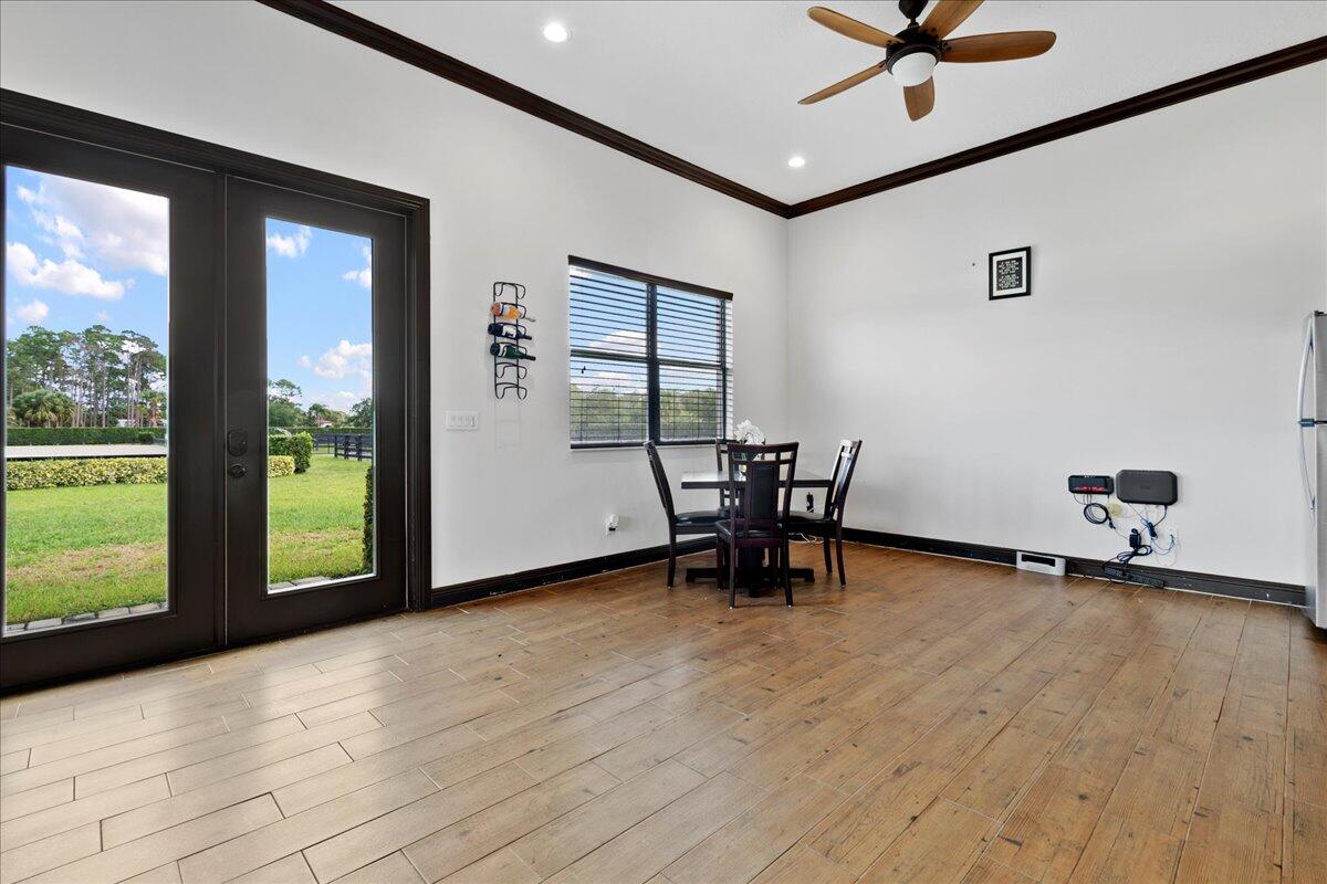 16575 Van Gogh Boulevard, Unit HORSE STALLS) Loxahatchee, FL 33470 - Photo 25 of 50 a view of an empty room with a window and wooden floor